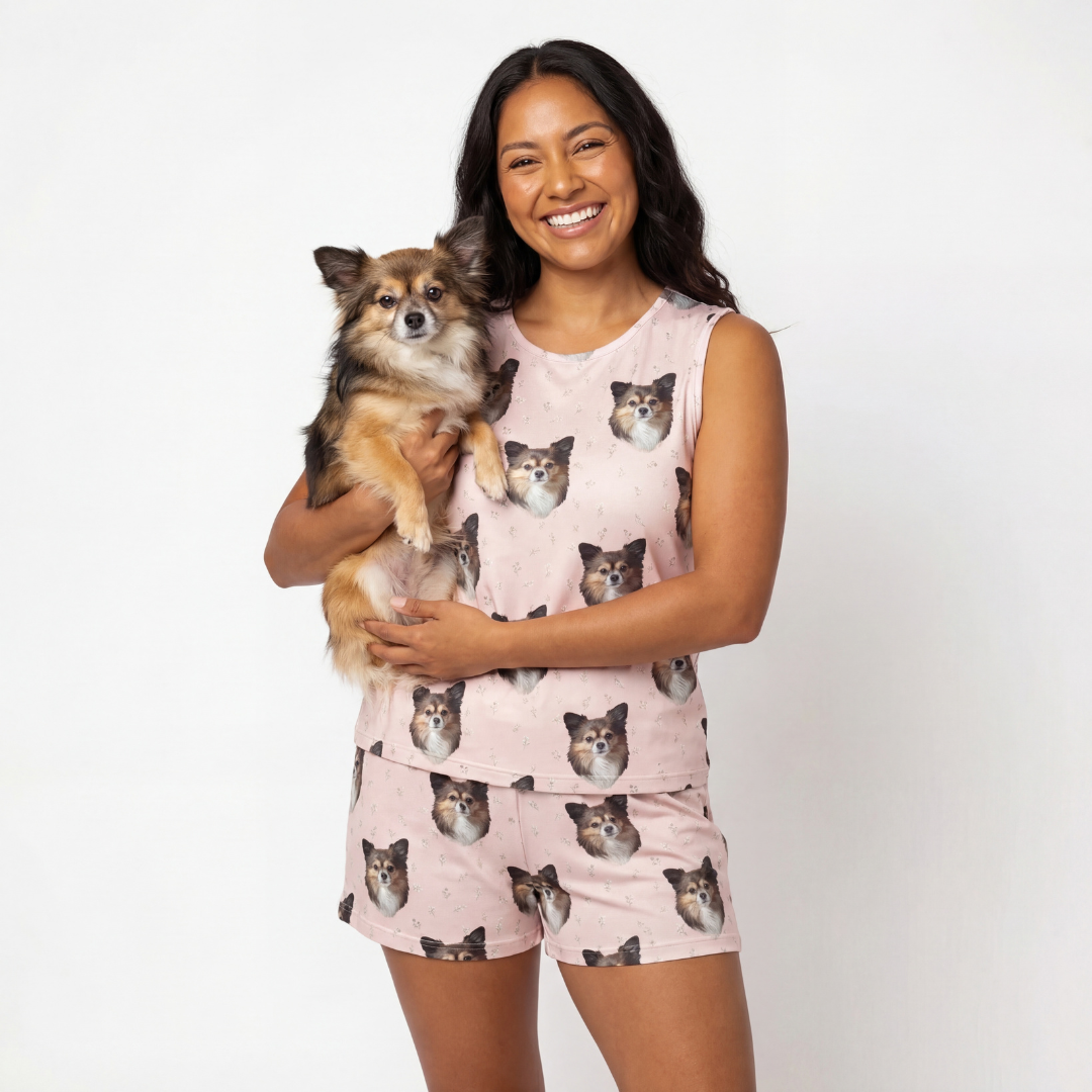 Woman wearing a tank top pajama with dog prints, holding a small dog[BlushBlossoms]