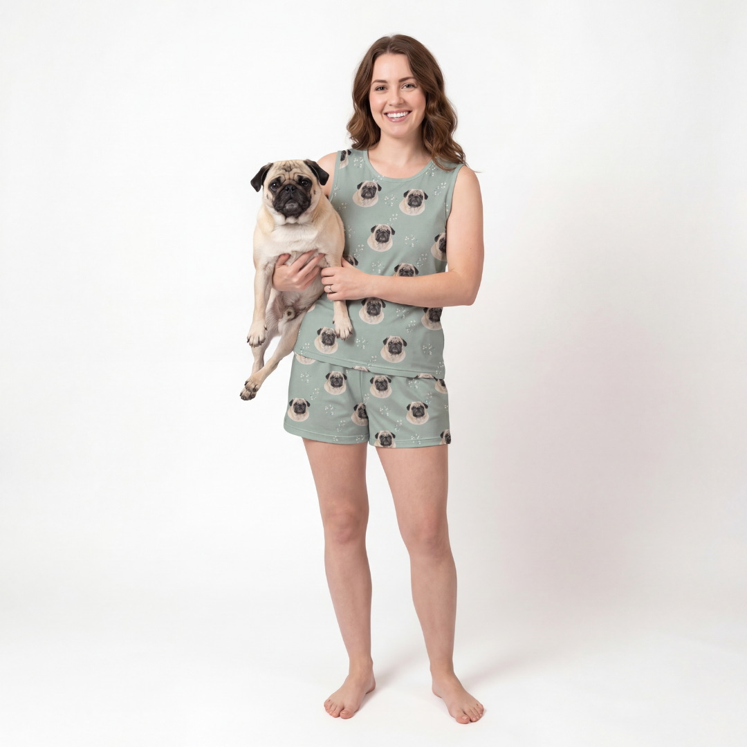 Woman wearing a pug-patterned tank top pajamas holding a pug on a white background[VintageBloom]