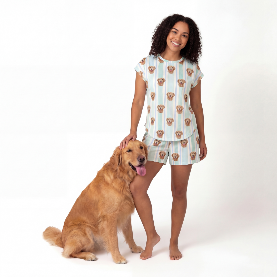 Woman wearing a patterned pajamas standing next to a dog on a white background[MintStripes]