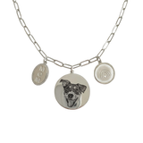 Silver necklace with a dog portrait charm and 'MOM' tag on a white background