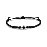 Black braided bracelets with a black bead charm in silver color