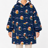 A person wearing a navy blue hooded sweatshirt with an all-over Christmas-themed print featuring Grinch faces, Santa hats, holly leaves, and the text 'The Grinch Christmas Vacation.' The photo is cropped from neck to upper thighs against a plain light background.
