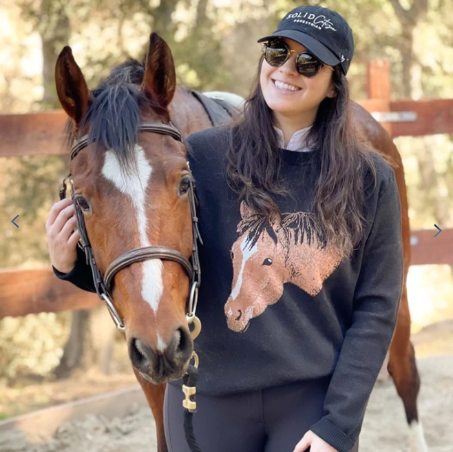 A girl wearing horse Pet knit Sweater