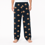 black pajama pants with dog pattern worn by a person on a white background