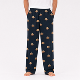 Black pajama pants with dog pattern worn by a person on a white background