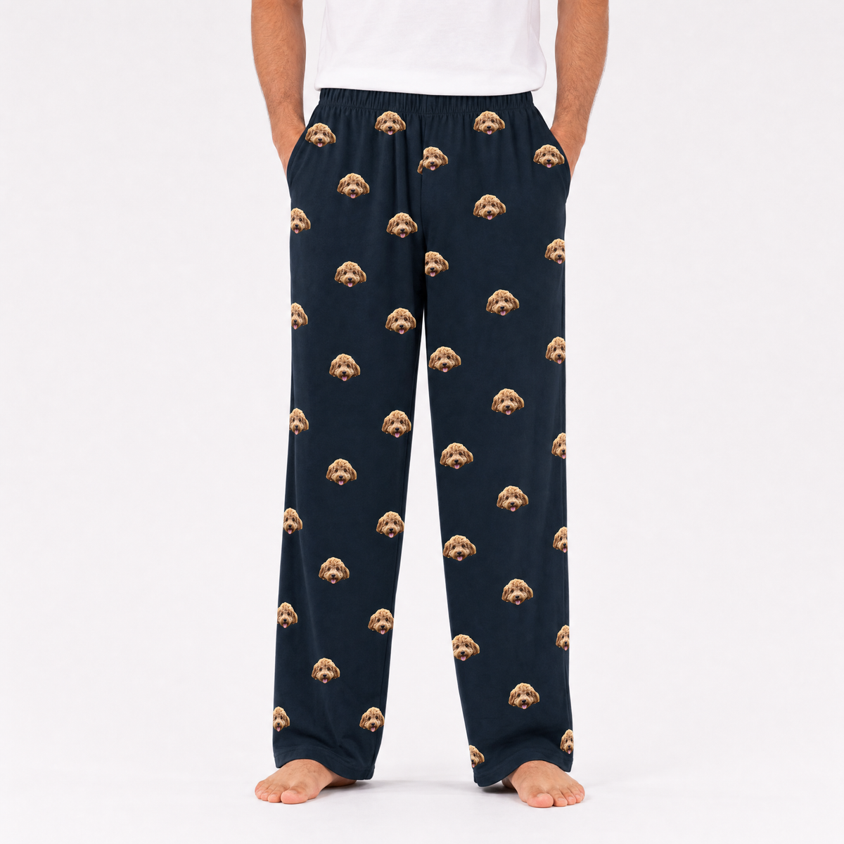 Black pajama pants with dog pattern worn by a person on a white background