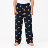 Black pajama pants with dog pattern worn by a person on a white background