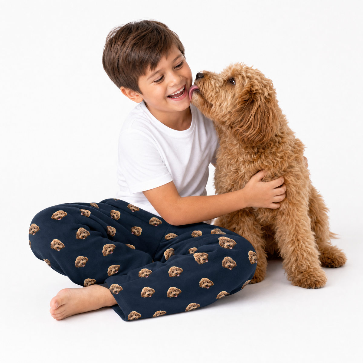 Navy blue theme – child in dog-print pajamas cuddling curly-haired dog.