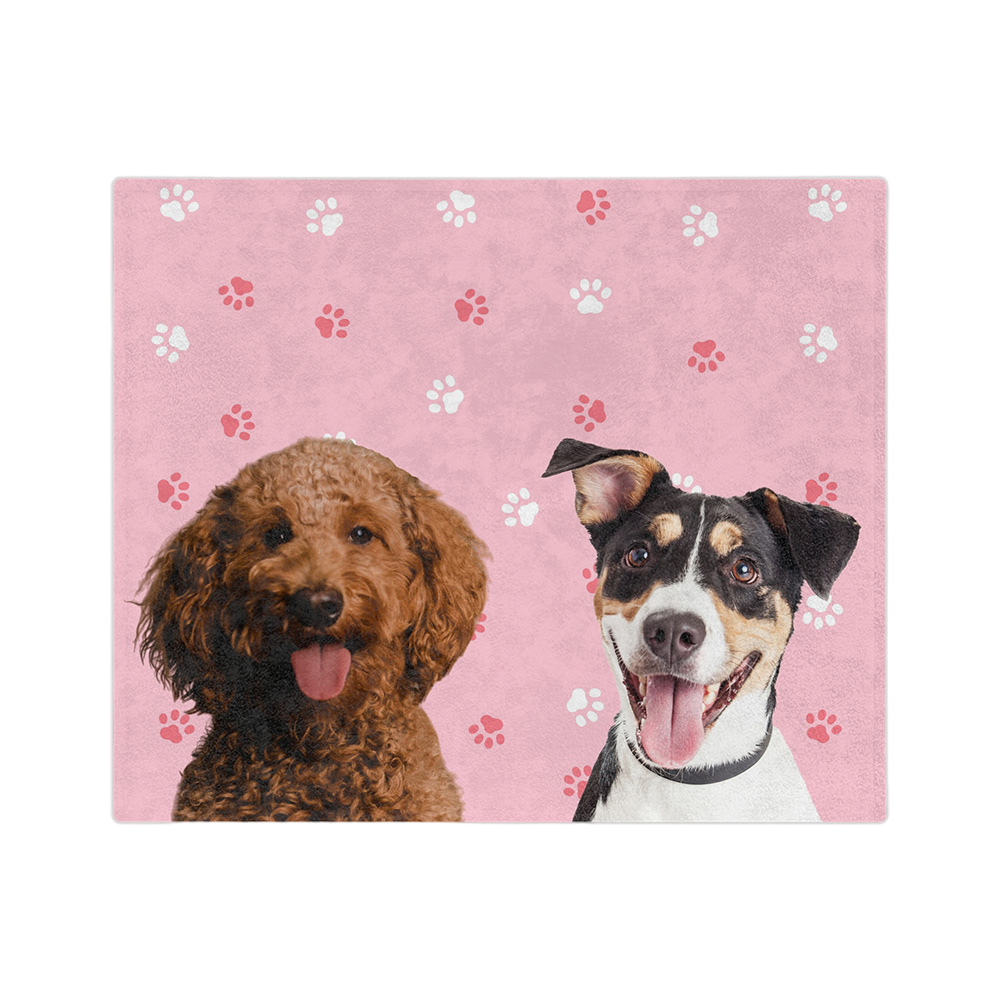 Pink blanket with paws featuring the portraits of two dogs 