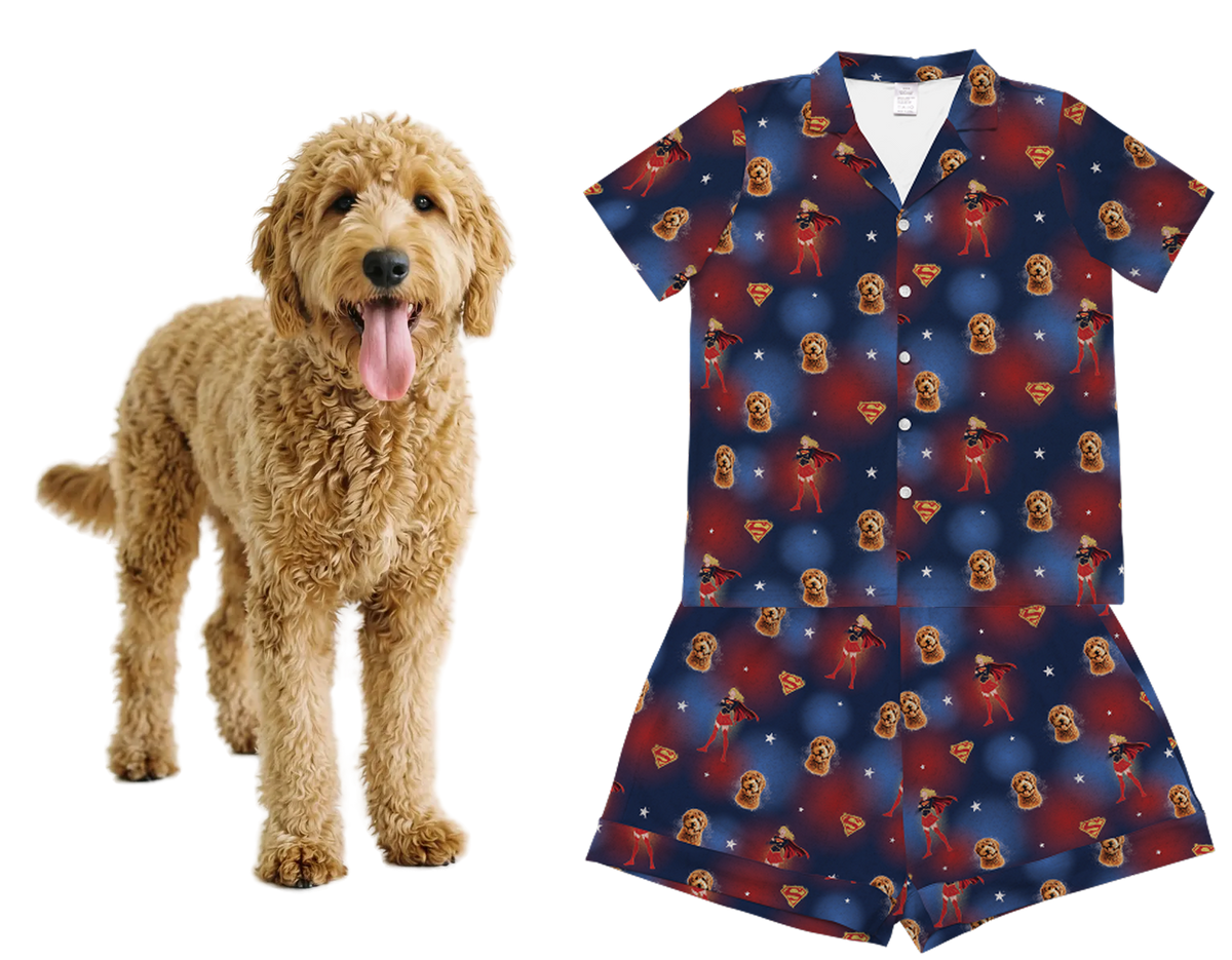 Dog next to a blue pajama set with red and white pattern on a white background