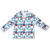 A long-sleeve collared shirt with a repeating pattern of cartoon penguins in winter outfits on a white background.