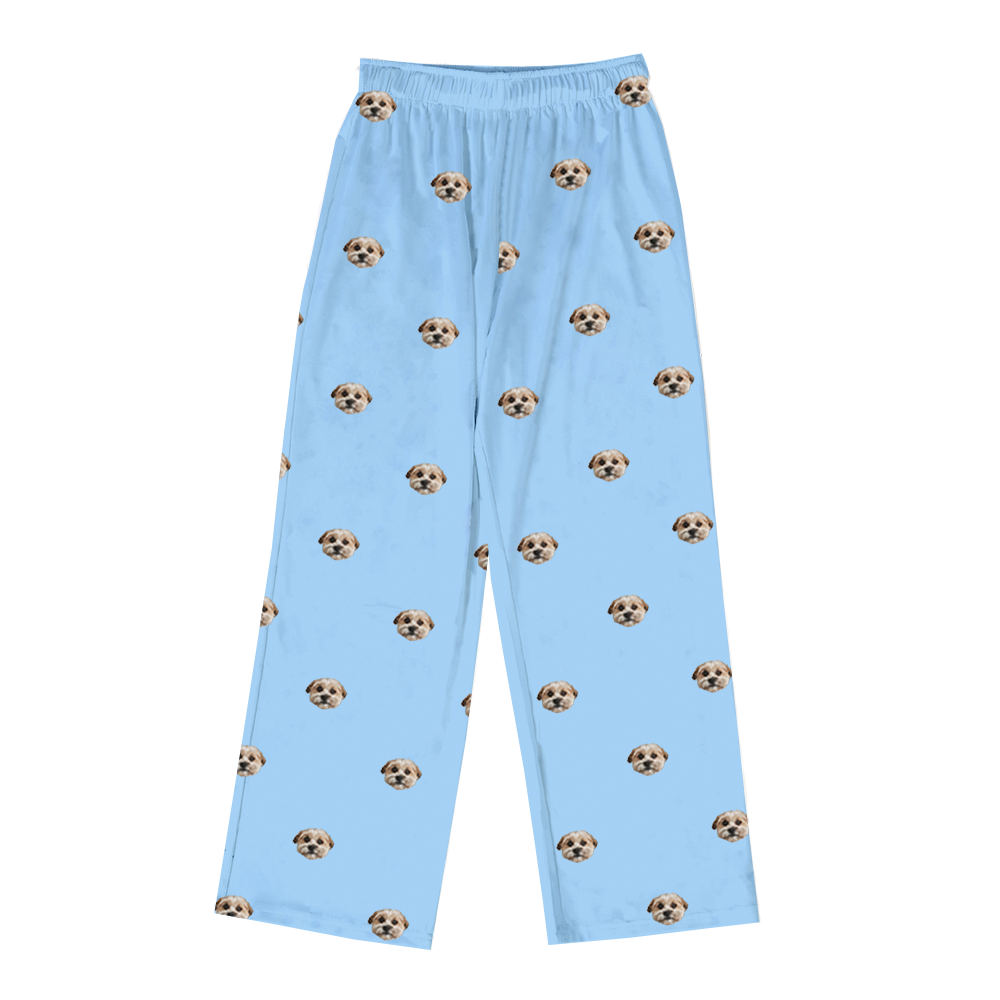 Sky blue pajama pants with dog face pattern on a white background