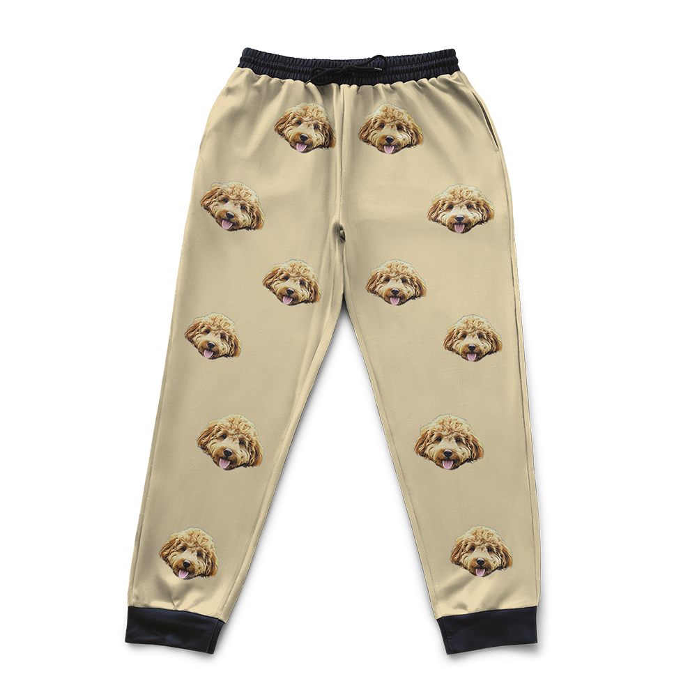 Yellow pajama pants with dog face pattern on a white background