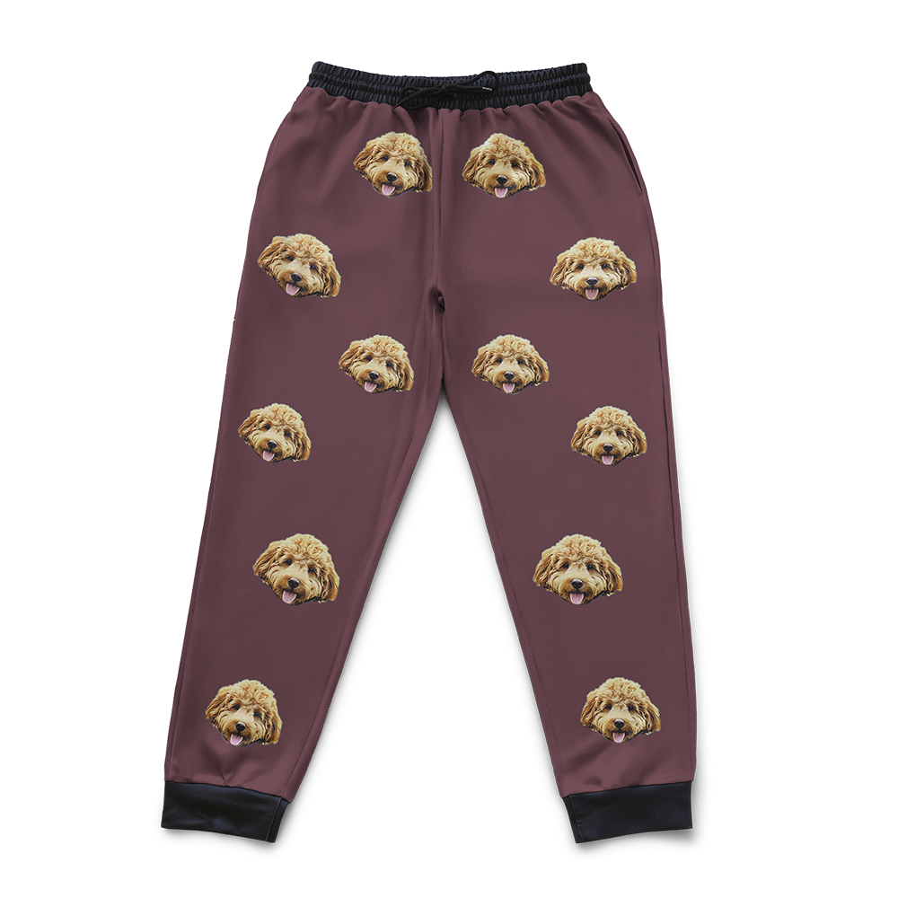 Maroon sweatpants featuring a repeating dog's face pattern.