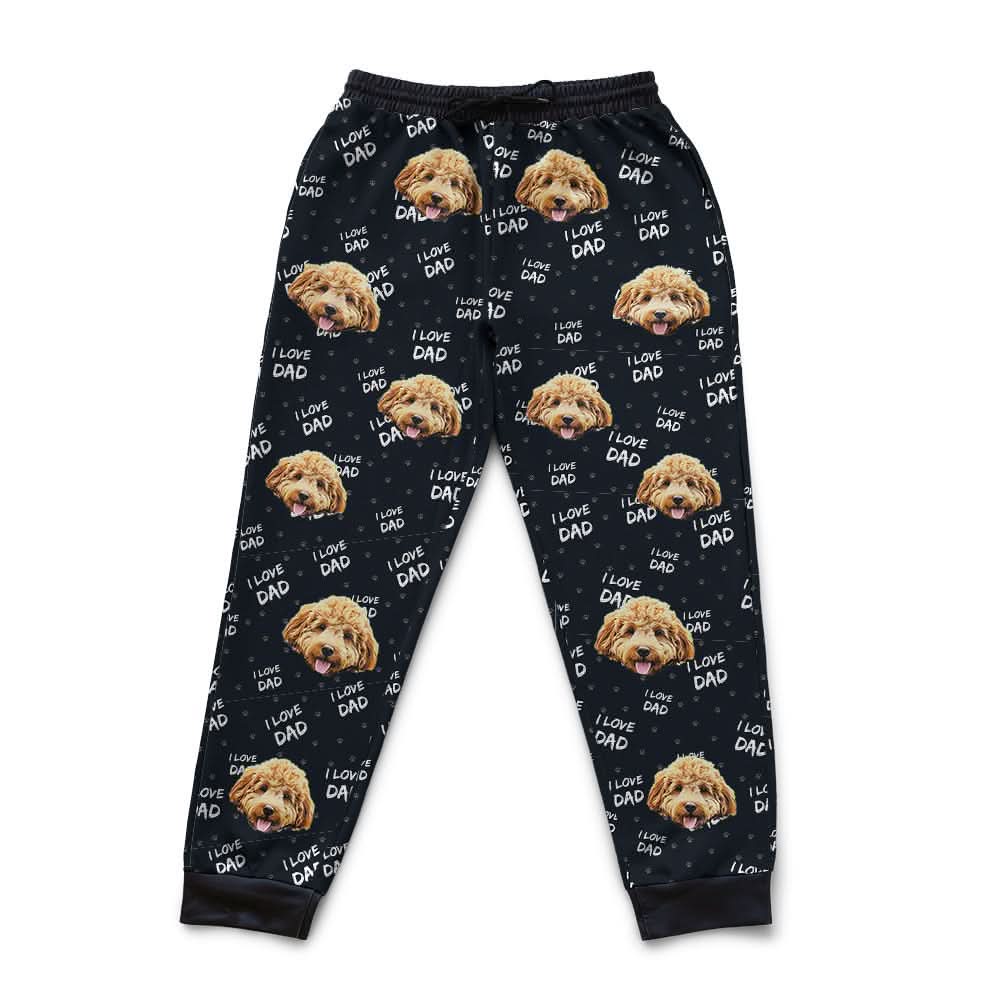 Black pajama pants with dog face pattern on a white background
