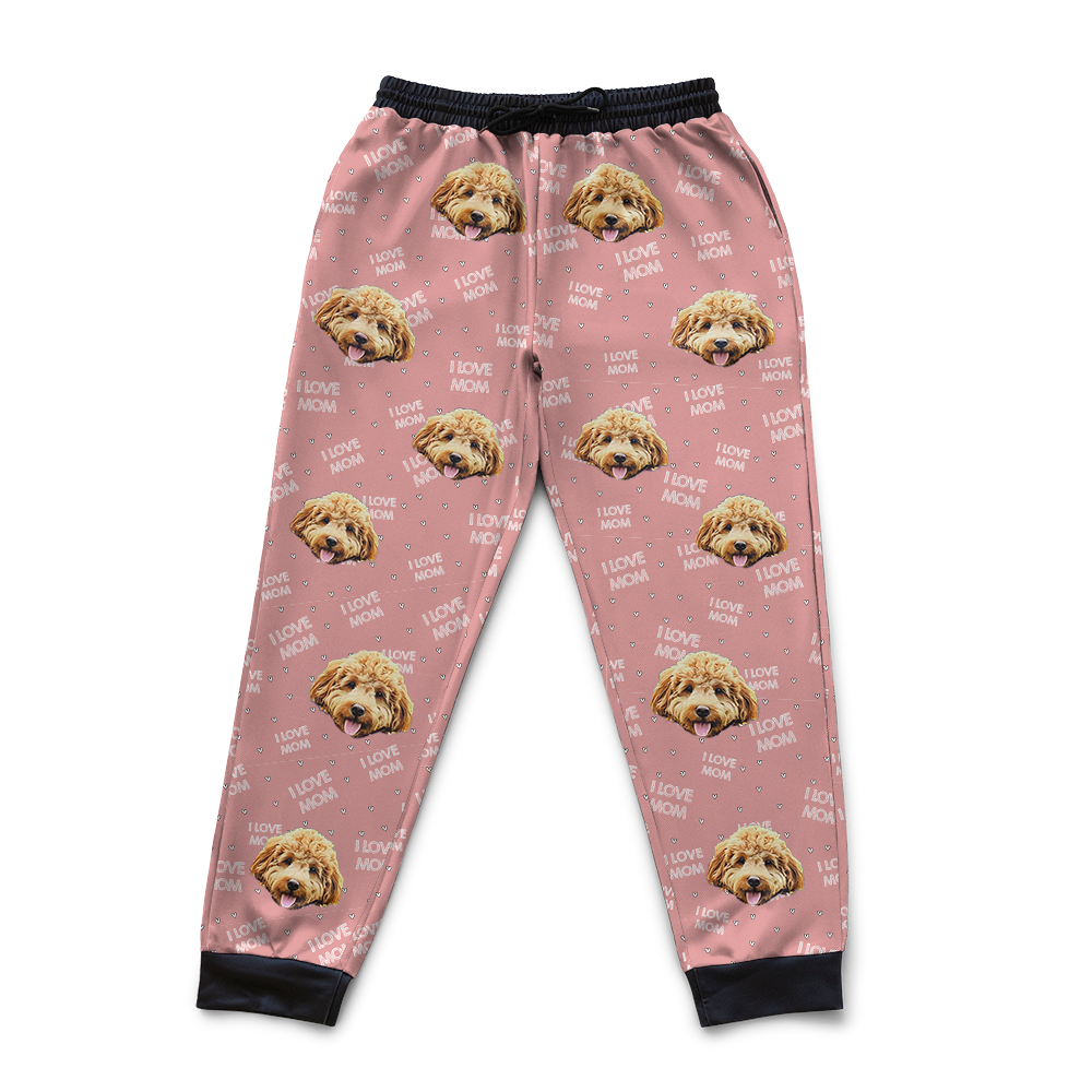 Pink pajama pants with dog face pattern on a white background