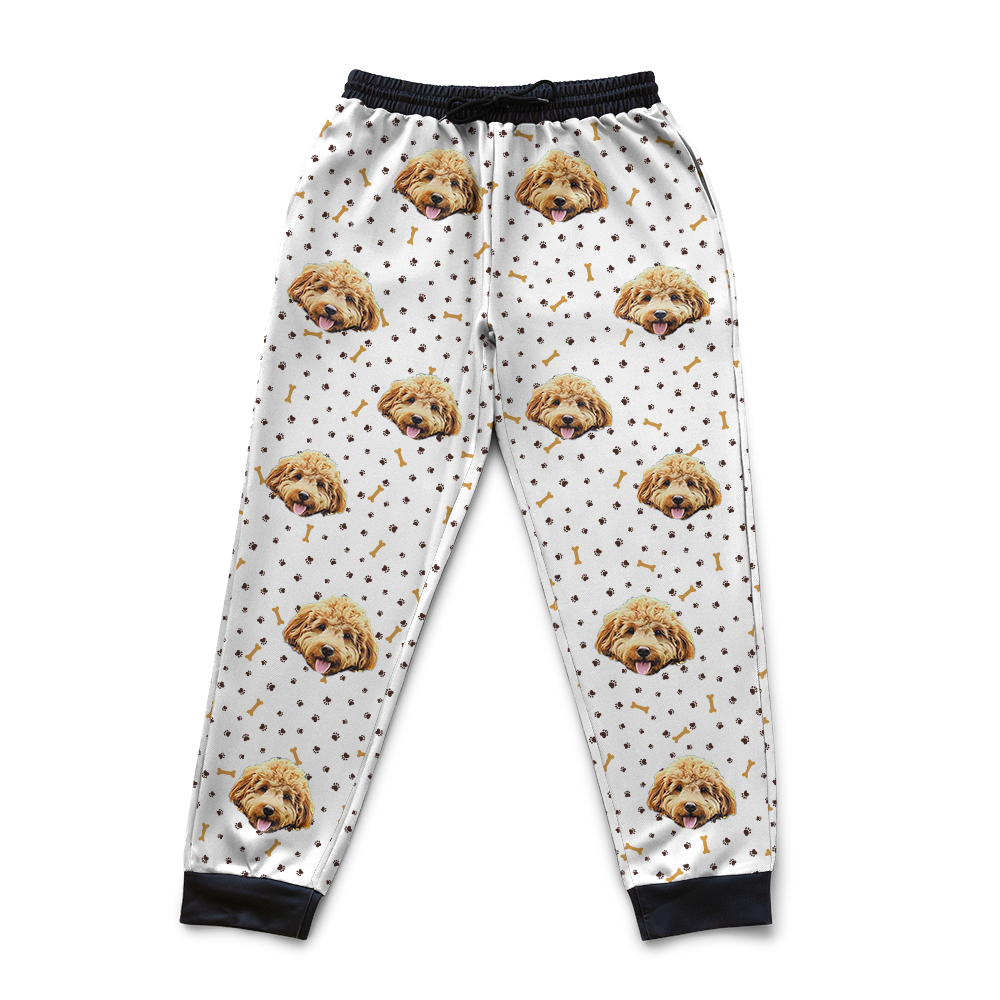 White pajama pants with dog face pattern on a white background