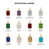 Collection of birthstone charms with corresponding months on a white background