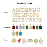 Collection of gold letter charms, birthstone pendants, and various other charms on a white background.