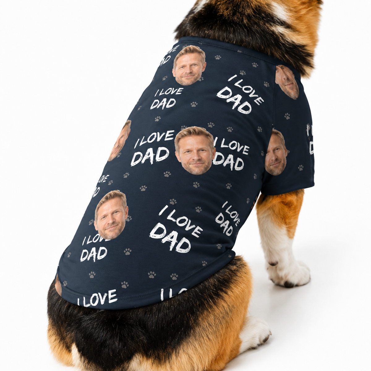 Corgi wearing a black custom dog shirt with “I Love Dad” text, paw prints, and a repeating face pattern.