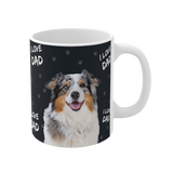 Black ceramic mug with paws and the phrase "I Love Dad", featuring a smiling, multicolored Australian Shepherd [ILoveMomImageCutOut]