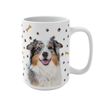 White ceramic mug with paws and bones pattern, featuring a smiling, multicolored Australian Shepherd [PawsandBonesImageCutOut]