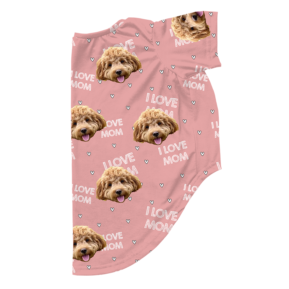 Pink dog pajama with repeating pet faces on them