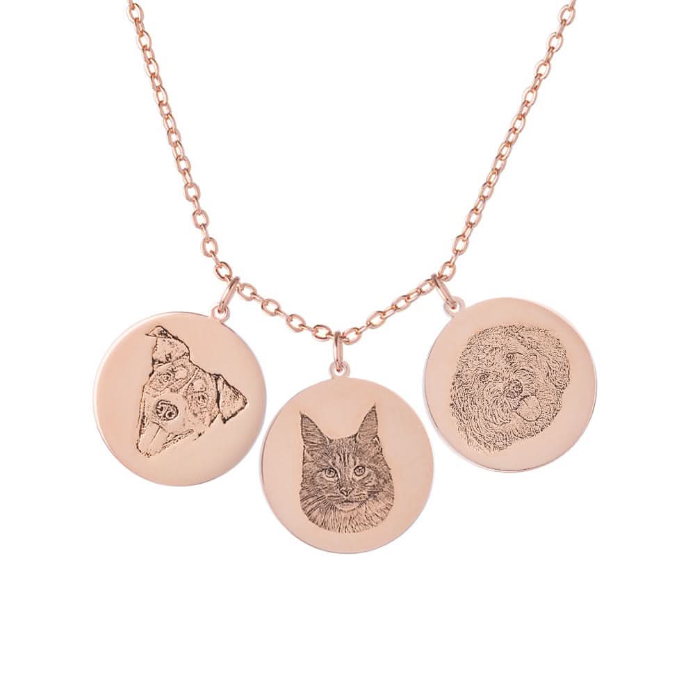 A necklace with three circular rose gold pendants, each engraved with a different pet portrait.