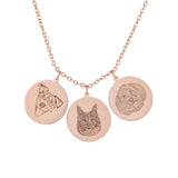 A necklace with three circular rose gold pendants, each engraved with a different pet portrait.