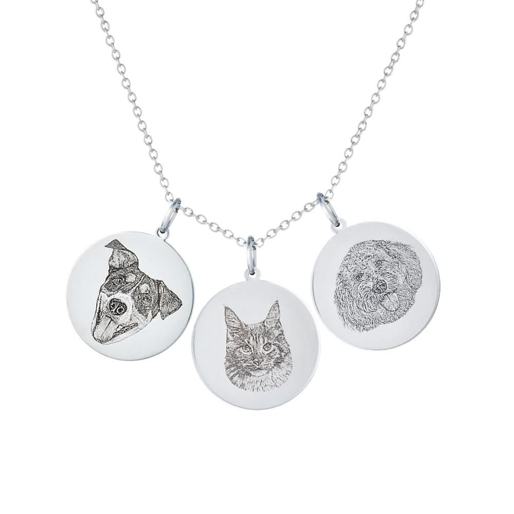 Silver necklace with three circular pendants featuring a dog, cat, and doodle