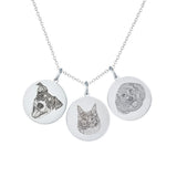 Silver necklace with three circular pendants featuring a dog, cat, and doodle