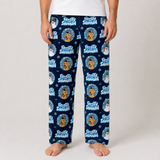 A person wearing navy blue pajama pants with a repeating 'Frosty Snowman' dog print, shown from the waist down against a light gray studio background.