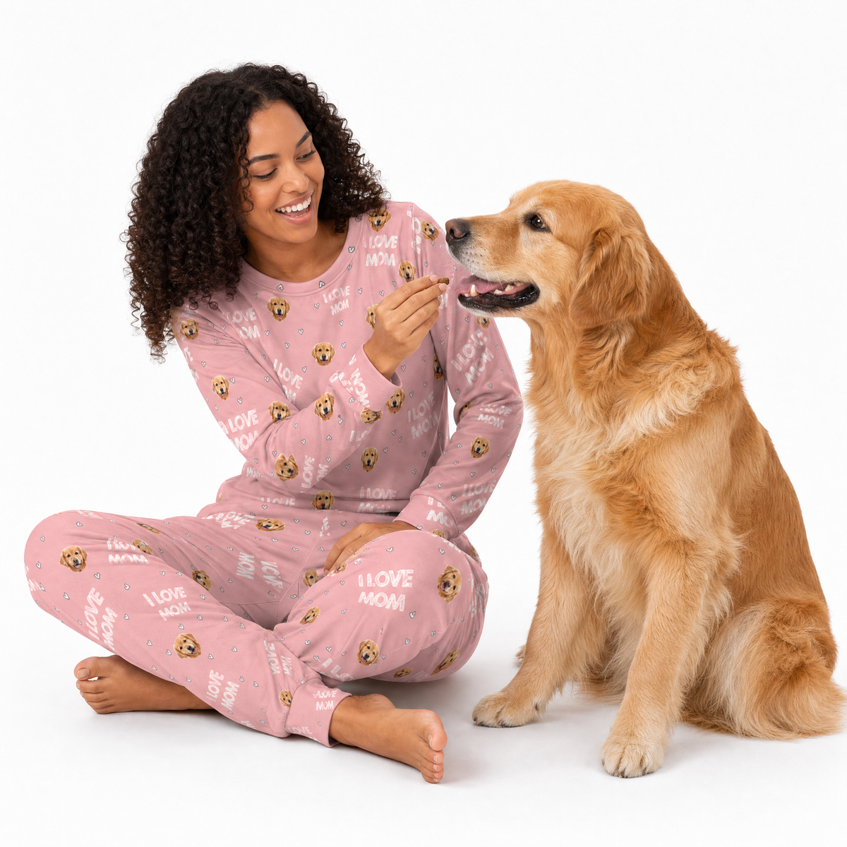 Woman in pink jogger pajamas with a dog on a white background