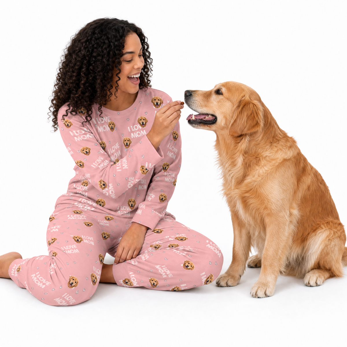 Woman in pink jogger pajamas with a dog on a white background