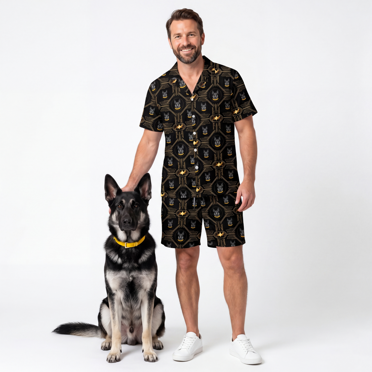 Man wearing a black patterned outfit standing next to a dog on a white background