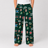A person wearing dark green Christmas-themed lounge pants with a festive print of Santa Claus, dogs, snow globes, and holiday text, shown against a light gray studio background.