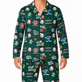 A man wearing a dark green Christmas-themed pajama set with an all-over print of Pomeranian dogs in Santa hats, holiday messages, and festive icons, shown against a plain white background.