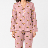 Pink pajama set with dog pattern on a white background
