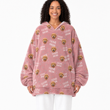 Woman wearing a pink blanket hoodie with dog graphics and 'I love mom' text on a white background