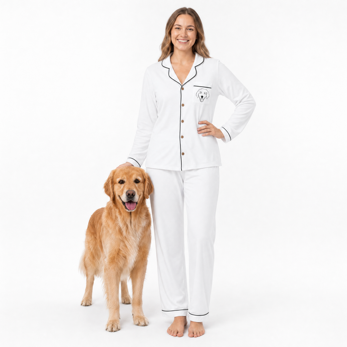 Woman wearing ivory pajamas with a dog standing next to her on a white background