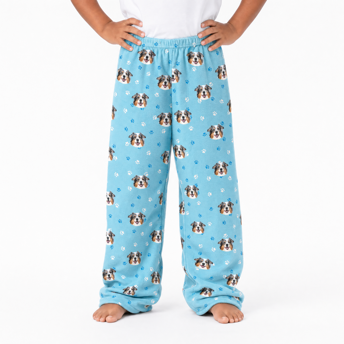 Light Blue pajama pants with dog pattern worn by a person on a white background
