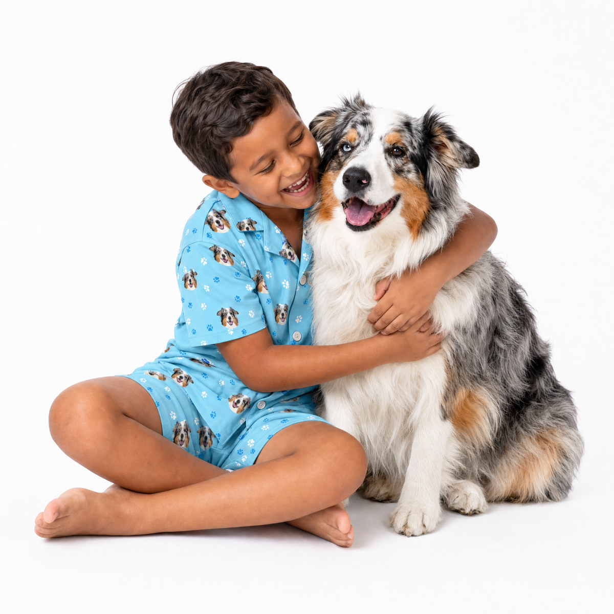 Child in light blue pajamas with a dog on a white background