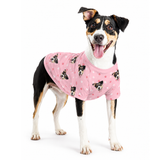 Dog wearing a light pink custom dog shirt with paw prints and a repeating dog face pattern.