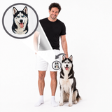 A man in a black t-shirt and white shorts stands next to a husky dog on a white background, with a circular inset showing a husky portrait and an arrow indicating a custom pet photo print product.