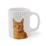 Custom 11oz ceramic mug with an orange tabby cat photo cutout portrait on a white background with red and green paw prints[ChristmasPawsImageCutOut]