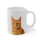 Custom 11oz ceramic mug with an orange tabby cat hand illustration portrait on a white background with red and green paw prints[ChristmasPawsHandIllustration]