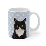 Custom 11oz ceramic mug with a tuxedo cat hand illustration portrait on a light blue gingham background with white snowflakes[SnowyGinghamHandIllustration]