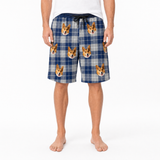 Person wearing blue plaid shorts with dog print on a white background