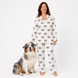 Woman wearing a patterned pajama set with a dog on a white background