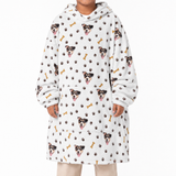 Person wearing a white blanket hoodie with dog and paw print pattern on a white background